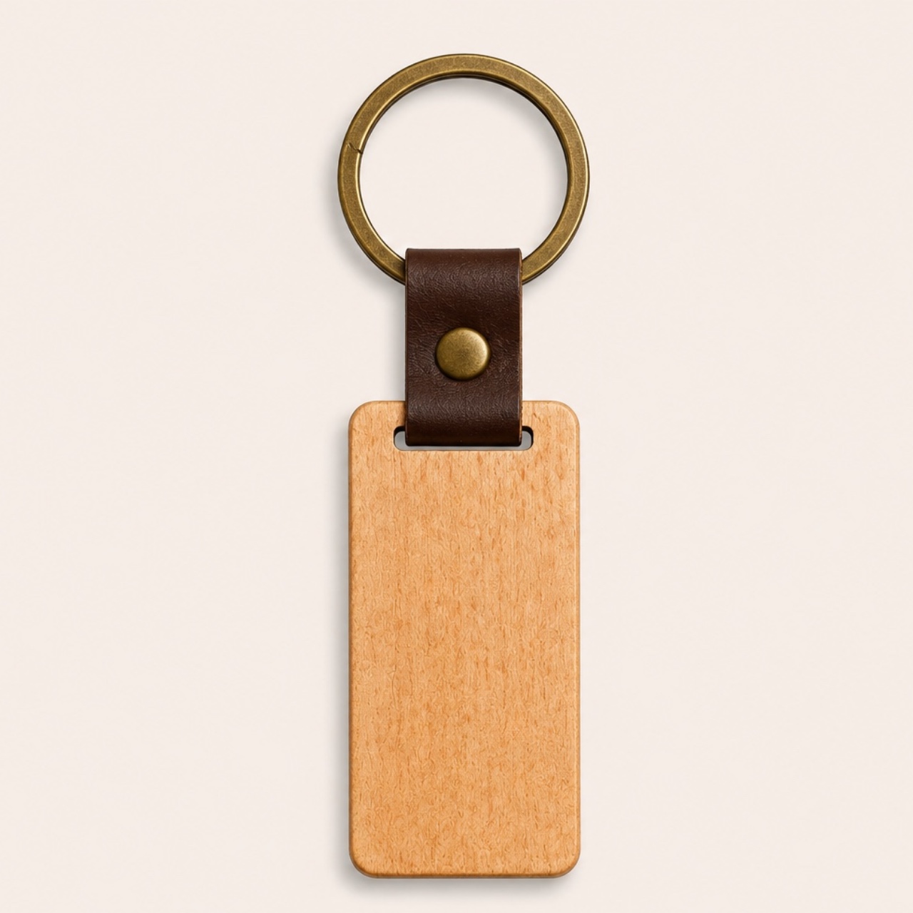 Blank leather-strap wooden key ring — a plain beech tag on a brown leather strap with an antique-brass ring, ready to be engraved with your own logo